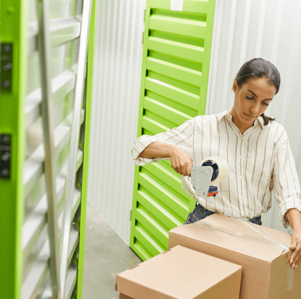 A woman organizing items in a self-storage unit.