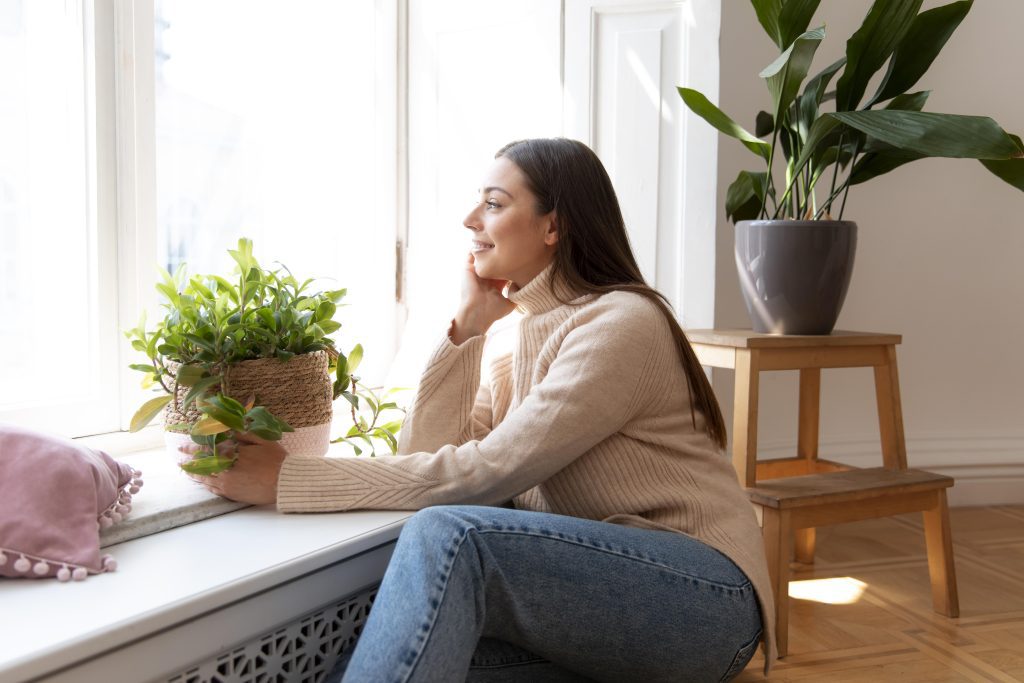 A woman enjoying a peaceful atmosphere in a tidy room by utilizing self storage, enhancing work-life balance for a more comfortable and productive life.